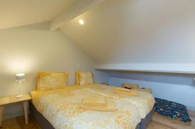 a bedroom with a bed with a hat on it at Luz & Alegria Place! in Porto