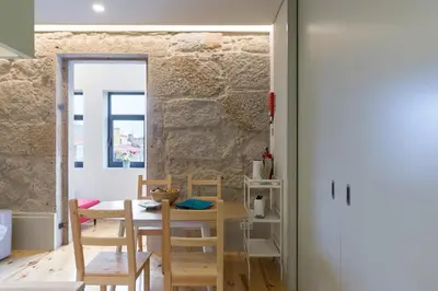 a kitchen and dining room with a table and chairs at Luz & Alegria Place! in Porto