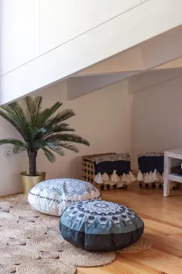 two ottomans in a living room with a palm tree at Beautiful Loft Downtown Porto in Porto