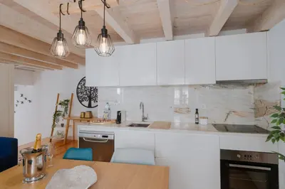 a kitchen with white appliances and a wooden ceiling at Lovely Nest Downtown Porto in Porto
