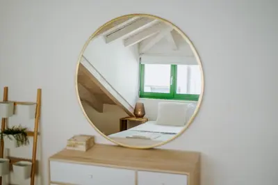 a round mirror on a dresser in a room at Lovely Nest Downtown Porto in Porto