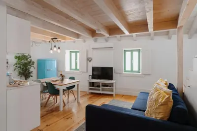 a living room with a blue couch and a table at Lovely Nest Downtown Porto in Porto