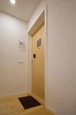 a hallway with a door and a sign on the wall at São Bento Hill View in Porto
