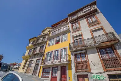 a yellow building with balconies on the side of it at São Bento Hill View in Porto