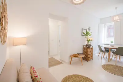 a white living room with a couch and a table at Porto City Cottage in Ribeira neighborhood in Porto