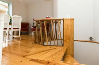 a wooden table sitting on top of a wooden floor at VIVA Ilda's Home in Porto