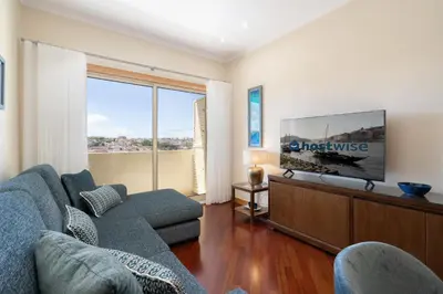 a living room with a couch and a flat screen tv at Host Wise - Anna Flats in Vila Nova de Gaia