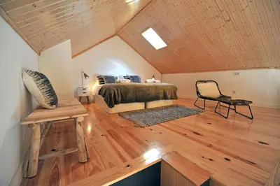 a bedroom with a bed and a chair in a room at FLH Oporto Wine Cellars Luxury Apartment II in Vila Nova de Gaia