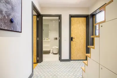 a bathroom with a toilet and a door to a bathroom with a tub at Santa Catarina Roof Top in Porto