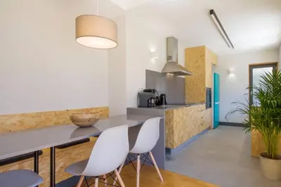 a kitchen with white chairs and a counter at Santa Catarina Roof Top in Porto