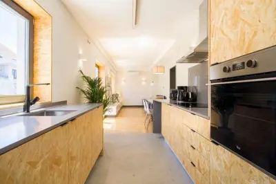 a kitchen with a sink and a stove top oven at Santa Catarina Roof Top in Porto