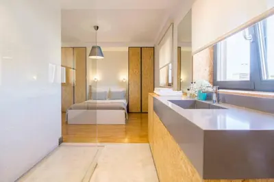 a kitchen with a sink and a room with a bed at Santa Catarina Roof Top in Porto
