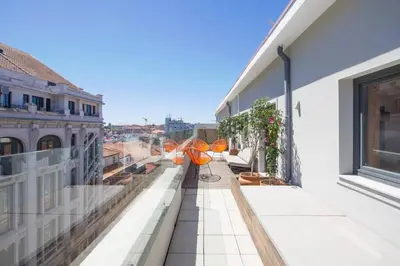 a balcony with two umbrellas on a building at Santa Catarina Roof Top in Porto