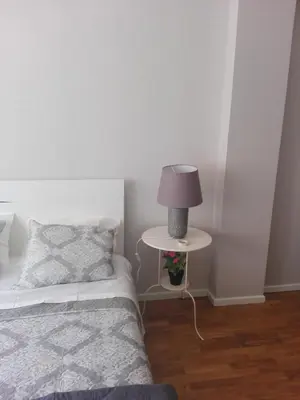 a bedroom with a bed and a lamp on a table at Secondlove in Porto