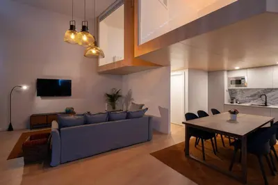 a living room with a couch and a table at Loft Douro Cais da Fontaínha in Vila Nova de Gaia