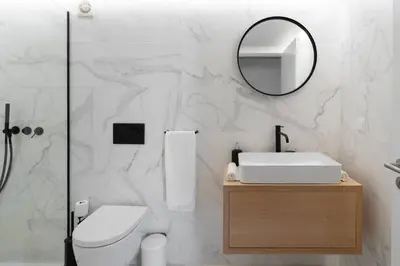 a white bathroom with a sink and a mirror at Loft Douro Cais da Fontaínha in Vila Nova de Gaia