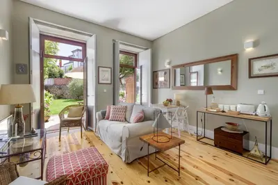 a living room with a couch and a table at Oporto MyWish City Central Apartment with Private Garden in Porto