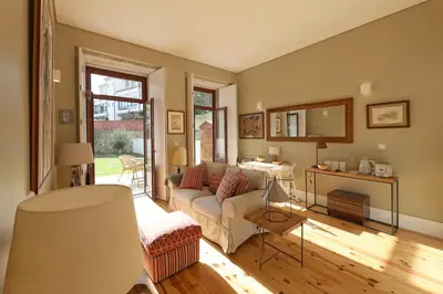 a living room with a couch and a table at Oporto MyWish City Central Apartment with Private Garden in Porto