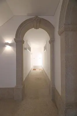 an empty hallway with an archway and a white wall at Oporto MyWish City Central Apartment with Private Garden in Porto