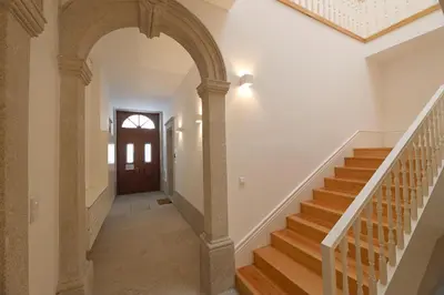 an archway leading up to a staircase in a house at Oporto MyWish City Central Apartment with Private Garden in Porto