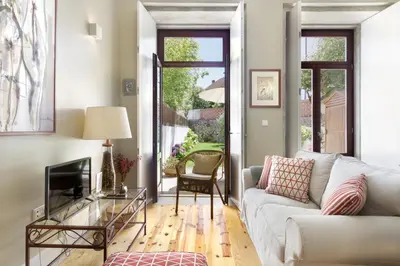 a living room with a couch and a tv at Oporto MyWish City Central Apartment with Private Garden in Porto