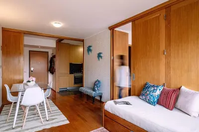 a living room with a white couch and a table at Porto bica velha - Carvalhido in Porto