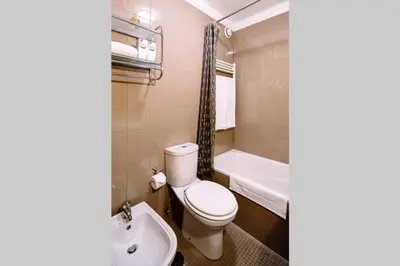 a bathroom with a toilet and a tub and a sink at Porto bica velha - Carvalhido in Porto