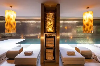 a room with a swimming pool with white stools at BessaHotel Baixa in Porto