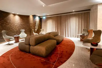 a living room with a couch and tables and chairs at BessaHotel Baixa in Porto
