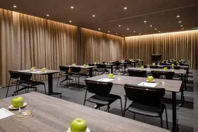 a dining room with tables and chairs with apples on them at BessaHotel Baixa in Porto