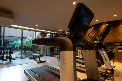 a room with a gym with a treadmill and a television at BessaHotel Baixa in Porto