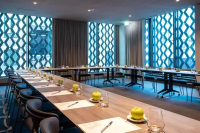 a large dining room with long tables and chairs at BessaHotel Baixa in Porto