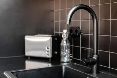 a kitchen sink with a soap bottle next to a toaster at Nomad's Family - 2BED Spacious Apartment Gaia in Vila Nova de Gaia