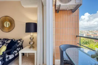 a room with a balcony with a couch and a table at Candal Douro in Vila Nova de Gaia