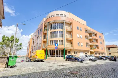 a large building with cars parked in front of it at Candal Douro in Vila Nova de Gaia