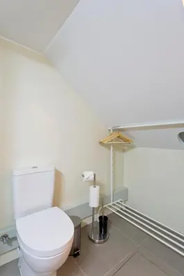 a bathroom with a white toilet in a room at Casas de Vera Cruz in Porto