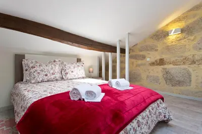 a bedroom with a bed with two towels on it at Casas de Vera Cruz in Porto