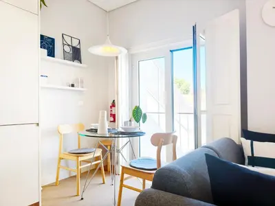 a living room with a couch and a table at D858 - comfort near downtown - AC & balcony in Porto