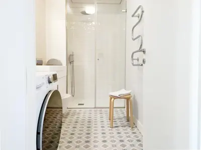 a bathroom with a shower and a toilet and a stool at D858 - comfort near downtown - AC & balcony in Porto