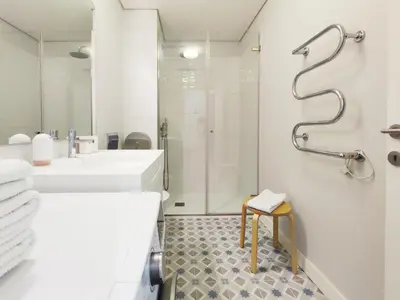 a white bathroom with two sinks and a shower at D858 - comfort near downtown - AC & balcony in Porto