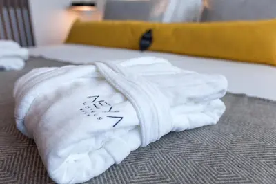 a pile of towels sitting on top of a bed at NEYA Porto Hotel in Porto