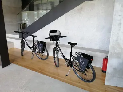 two bikes parked on a wooden floor in a room at NEYA Porto Hotel in Porto