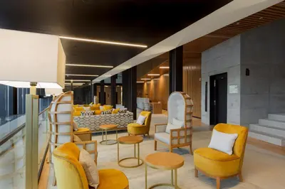 a waiting area with chairs and tables in a building at NEYA Porto Hotel in Porto