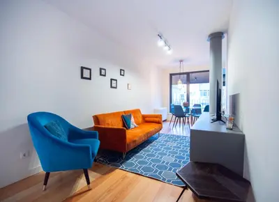 a living room with a couch and a blue chair at Oporto City View - Alves da Veiga in Porto
