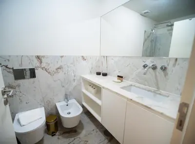 a white bathroom with a toilet and a sink at Oporto City View - Alves da Veiga in Porto