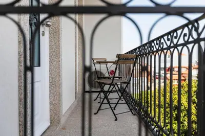 a balcony with a chair and a table on it at Oporto Down Town in Porto