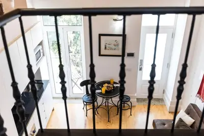 a small table in a living room with a staircase at Oporto Down Town in Porto