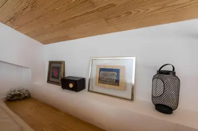 a white wall with two framed pictures and a speaker at Oporto Down Town in Porto