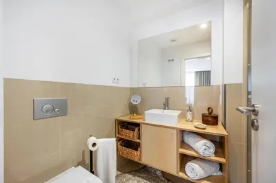 a kitchen and dining room with a glass table and chairs at Casas do Porto - Ribeira Apartments in Porto