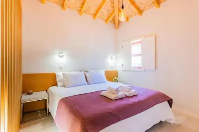 a bedroom with a bed with two towels on it at Lemago Porto Apartments - São Bento in Porto
